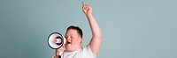 Cute boy with down syndrome using a megaphone to amplify his voice  