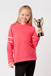 Young girl with down syndrome holding a trophy 