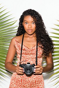 Beautiful black woman with an analog camera