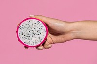 Woman holding a sliced dragon fruit 