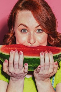 Woman biting into a slice of watermelon