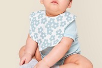 Baby wearing flower pattern apron in studio
