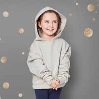 Little cute girl in a beige hoodie