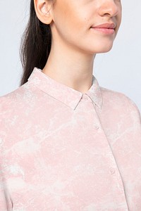 Beautiful woman wearing marble pink shirt close up