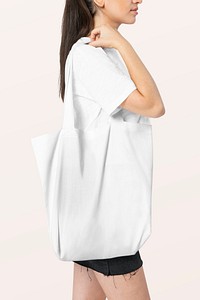 Woman carrying white tote bag studio shoot