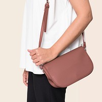Woman carrying her pink leather crossbody bag