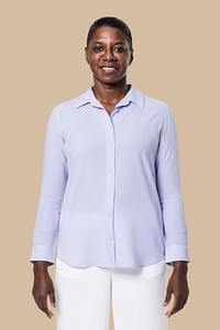 African American woman wearing blue long-sleeve shirt with white pants 
