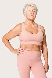 Healthy senior woman in pink sports bra and leggings