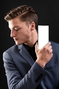 Businessman in suit showcasing his mobile phone technology