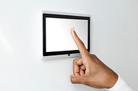 Finger pressing on smart home automation panel monitor