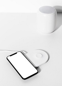 Smartphone on white wireless charger pad 