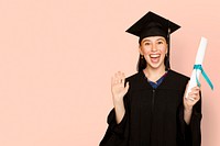 Woman wearing regalia holding her degree for graduation