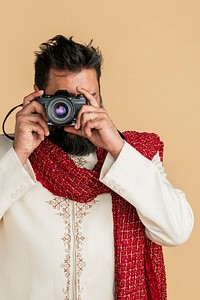Indian man in a kurta with a digital camera 