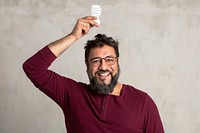 Happy Indian man holding a light bulb 