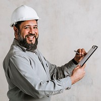 Indian engineer writing on a paper clipboard