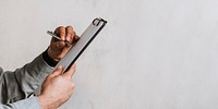 Engineer writing a report on a paper clipboard