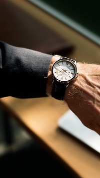 Businessman looking at his watch closeup