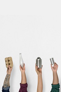 Hands holding recyclable objects border on white background