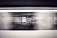 A long-exposure shot of a moving subway train and advertisement posters at the station. Original public domain image from <a href="https://commons.wikimedia.org/wiki/File:Subway_train_in_motion_(Unsplash).jpg" target="_blank" rel="noopener noreferrer nofollow">Wikimedia Commons</a>
