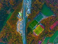 A colorful aerial shot of a highway running next to soccer pitches with light reflecting off buildings. Original public domain image from <a href="https://commons.wikimedia.org/wiki/File:Light_reflections_by_the_highway_(Unsplash).jpg" target="_blank" rel="noopener noreferrer nofollow">Wikimedia Commons</a>
