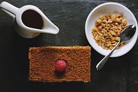 Flat lay of breakfast cake, syrup, and hazelnuts. Original public domain image from <a href="https://commons.wikimedia.org/wiki/File:Honey_Cake_(Unsplash).jpg" target="_blank" rel="noopener noreferrer nofollow">Wikimedia Commons</a>