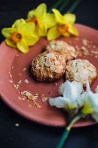 Almond cookies on a pink plate with yellow flowers. Original public domain image from <a href="https://commons.wikimedia.org/wiki/File:Almond_Cookies_(Unsplash).jpg" target="_blank" rel="noopener noreferrer nofollow">Wikimedia Commons</a>