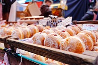 Fresh donuts with red filling on display in a market filled with people. Original public domain image from <a href="https://commons.wikimedia.org/wiki/File:Jelly_Doughnuts_(Unsplash).jpg" target="_blank" rel="noopener noreferrer nofollow">Wikimedia Commons</a>