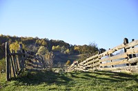 A wooden fence on a hill in the countryside. Original public domain image from <a href="https://commons.wikimedia.org/wiki/File:Rustic_fence_(Unsplash).jpg" target="_blank" rel="noopener noreferrer nofollow">Wikimedia Commons</a>