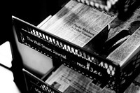 A black-and-white shot of newspapers in a store. Original public domain image from <a href="https://commons.wikimedia.org/wiki/File:Newsstand_(Unsplash).jpg" target="_blank" rel="noopener noreferrer nofollow">Wikimedia Commons</a>