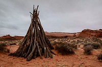 Sticks form a rustic teepee in the desert. Original public domain image from Wikimedia Commons
