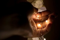 Person holding fairy lights. Original public domain image from Wikimedia Commons