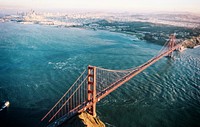 Drone view of San Francisco Golden Gate Bridge over crystal blue water and harbor in background. Original public domain image from <a href="https://commons.wikimedia.org/wiki/File:(NOT_A)_Drone_view_of_golden_gate_bridge_(Unsplash).jpg" target="_blank" rel="noopener noreferrer nofollow">Wikimedia Commons</a>