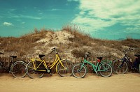 Colorful bicycles leaned on a wooden fence at the Formentera beach. Original public domain image from Wikimedia Commons