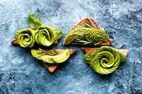 Pieces of toast with avocado arranged in the shape of a rose on them. Original public domain image from <a href="https://commons.wikimedia.org/wiki/File:Avocado_Rose_Toast_(Unsplash).jpg" target="_blank" rel="noopener noreferrer nofollow">Wikimedia Commons</a>