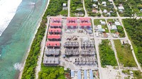 A drone shot of a small housing complex near the ocean shore. Original public domain image from <a href="https://commons.wikimedia.org/wiki/File:Housing_complex_in_Maldives_(Unsplash).jpg" target="_blank" rel="noopener noreferrer nofollow">Wikimedia Commons</a>