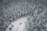 Aerial drone view of a car on a winding snow covered road through pine forest in Mount Hood National Forest. Original public domain image from Wikimedia Commons