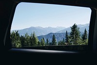 View from a car window on wooded slopes on a sunny day. Original public domain image from <a href="https://commons.wikimedia.org/wiki/File:Road_trip_along_the_green_mountains_(Unsplash).jpg" target="_blank" rel="noopener noreferrer nofollow">Wikimedia Commons</a>