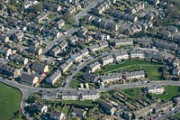 Drone view of residential houses with cars parked along street. Original public domain image from Wikimedia Commons