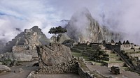 Ruins of the ancient Incan citadel Machu Picchu on a misty morning. Original public domain image from Wikimedia Commons