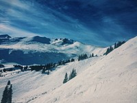 Snow covered mountains and trees with a dark blue sky in Keystone Ski Resort.. Original public domain image from <a href="https://commons.wikimedia.org/wiki/File:Snow_covered_mountains_in_Keystone_Ski_Resort_(Unsplash).jpg" target="_blank" rel="noopener noreferrer nofollow">Wikimedia Commons</a>