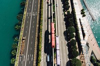 A drone shot of urban trains in the middle of a freeway in singapore. Original public domain image from <a href="https://commons.wikimedia.org/wiki/File:Singapore_freeway_(Unsplash).jpg" target="_blank" rel="noopener noreferrer nofollow">Wikimedia Commons</a>
