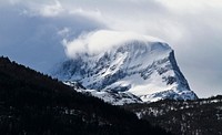 Wind blowing snow off a steep mountain. Original public domain image from Wikimedia Commons