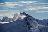 A snowy landscape with several tall peaks in Titlis. Original public domain image from <a href="https://commons.wikimedia.org/wiki/File:Windy_mountains_(Unsplash).jpg" target="_blank" rel="noopener noreferrer nofollow">Wikimedia Commons</a>