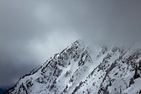 A snow-covered mountain's summit shrouded in thick fog. Original public domain image from <a href="https://commons.wikimedia.org/wiki/File:Mountain_summit_in_mist_(Unsplash).jpg" target="_blank" rel="noopener noreferrer nofollow">Wikimedia Commons</a>