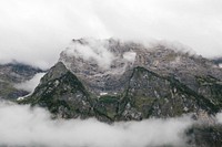 Clouds over a rocky mountain landscape. Original public domain image from Wikimedia Commons