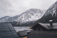 Rooftop view of houses and snow covered mountains surrounding it with water in Hallstatt.. Original public domain image from <a href="https://commons.wikimedia.org/wiki/File:Hallstatt,_Austria_(Unsplash_GAO_A4qQsiM).jpg" target="_blank" rel="noopener noreferrer nofollow">Wikimedia Commons</a>