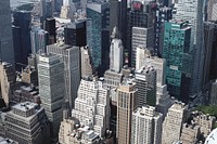 A high view of high-rises and skyscrapers in New York. Original public domain image from <a href="https://commons.wikimedia.org/wiki/File:Aerial_photograph_of_Midtown_Manhattan,_New_York--Unsplash.com--2016.jpg" target="_blank" rel="noopener noreferrer nofollow">Wikimedia Commons</a>