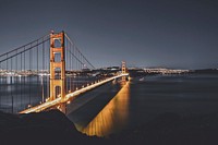 An illuminated Golden Gate Bridge photo with reflections in the water below. Original public domain image from <a href="https://commons.wikimedia.org/wiki/File:Golden_Gate_Bridge_(Unsplash).jpg" target="_blank" rel="noopener noreferrer nofollow">Wikimedia Commons</a>
