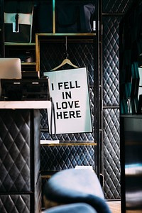 Sign on a hanger in luxurious environment reads, "I fell in love here.". Original public domain image from <a href="https://commons.wikimedia.org/wiki/File:I_fell_in_love_here_sign_(Unsplash).jpg" target="_blank" rel="noopener noreferrer nofollow">Wikimedia Commons</a>