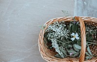 An overhead shot of a wicker basket with baby's-breath and other flowers. Original public domain image from Wikimedia Commons
